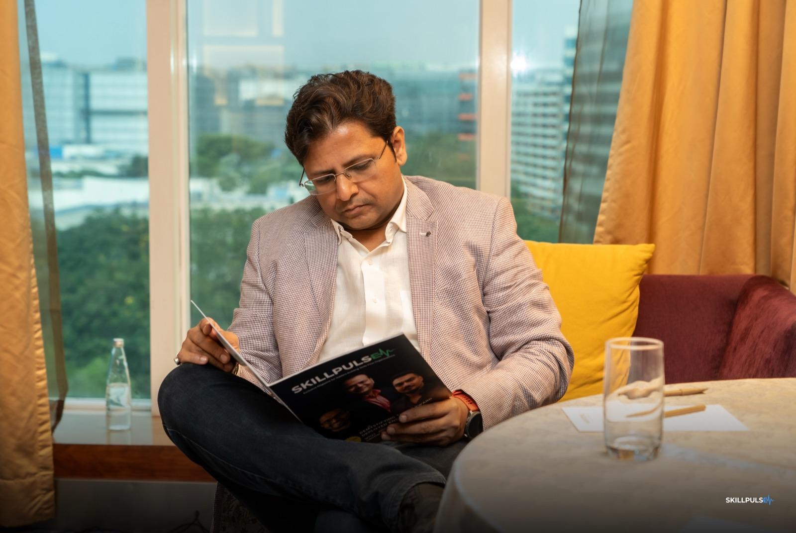 A leader reading SkillPulse Edition 02 at the community meet