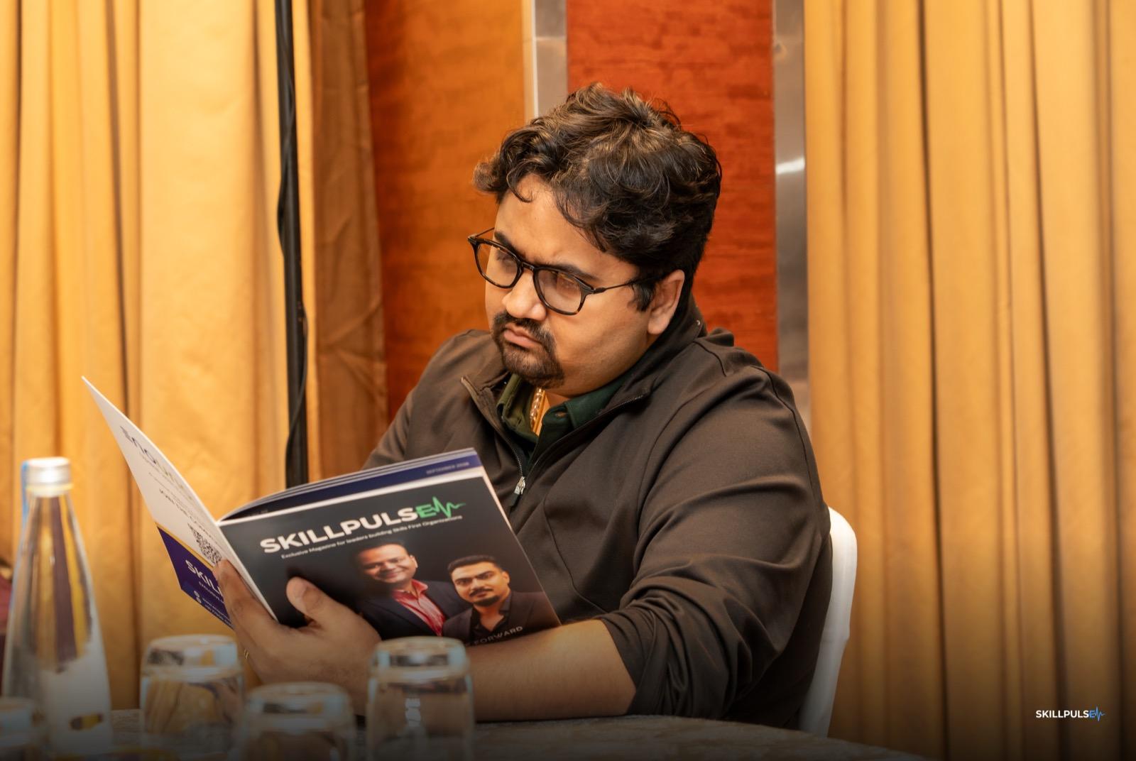 An attendee reading the new SkillPulse edition cover to cover